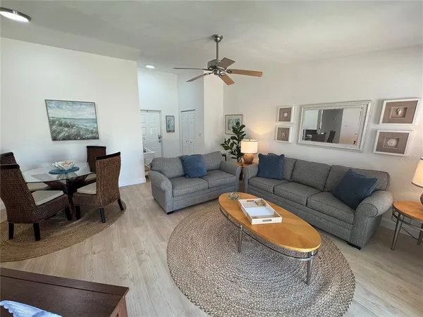 a living room with furniture and a chandelier