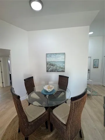 a dining room with furniture and wooden floor