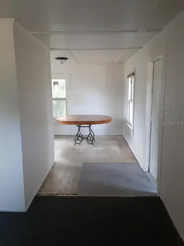 a view of a livingroom with a chair and a window