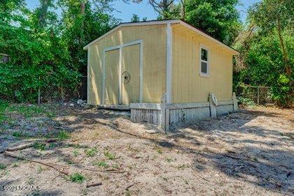 24 Sanders Road Wilmington, NC 28412 - Photo 24 of 28 Large storage shed also houses well pump equipment.