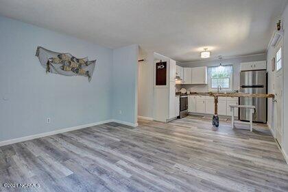 24 Sanders Road Wilmington, NC 28412 - Photo 10 of 28 Gray laminate flooring lends a crisp, clean look.