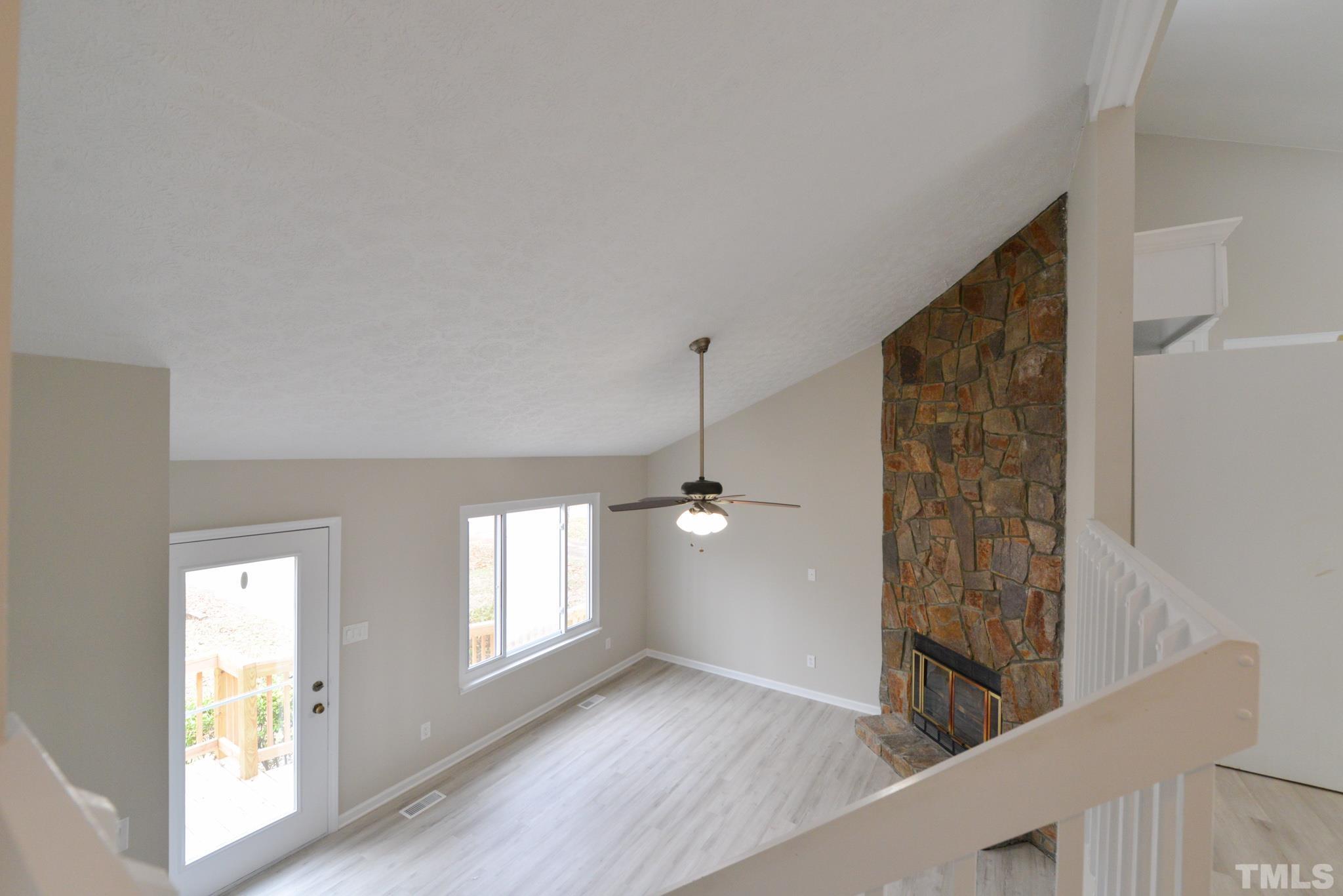 4104 Labrador Drive Raleigh, NC 27616 - Photo 15 of 38 a view of an empty room with window and wooden floor