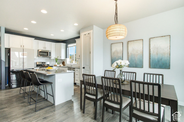 986 South Old Farm Road Heber City, UT 84032 - Photo 17 of 51 Open-concept kitchen featuring white cabinetry, stainless steel appliances, and a central island with bar seating