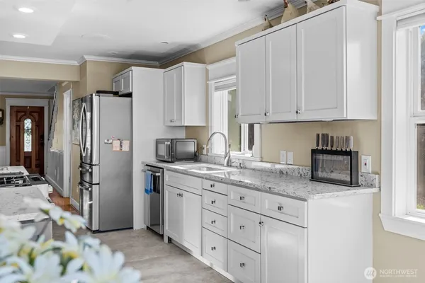 a living room with furniture and a dining table