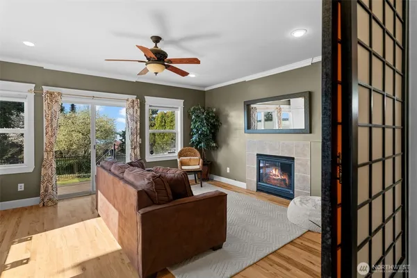 a living room with furniture a desk and a window
