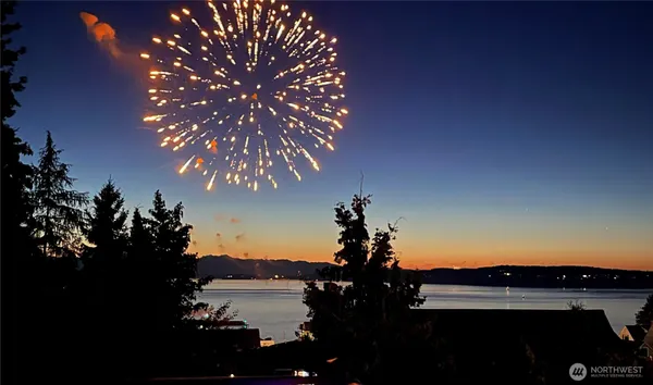 a spacious bathroom with a double vanity sink a mirror and shower