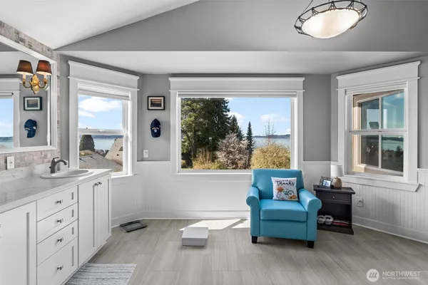 a bathroom with a double vanity sink a toilet a mirror and shower