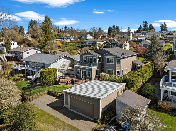 a view of a white house with a swimming pool and furniture