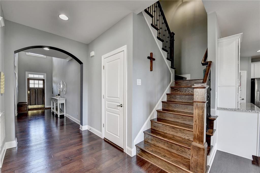 4071 Woodward Walk Lane Suwanee, GA 30024 - Photo 21 of 50 a view of a hallway with wooden floor and staircase