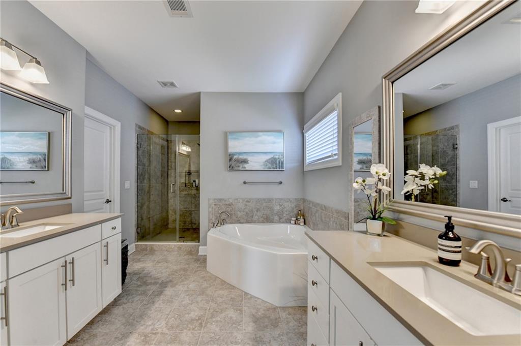 4071 Woodward Walk Lane Suwanee, GA 30024 - Photo 31 of 50 a bathroom with a sink and a bathtub