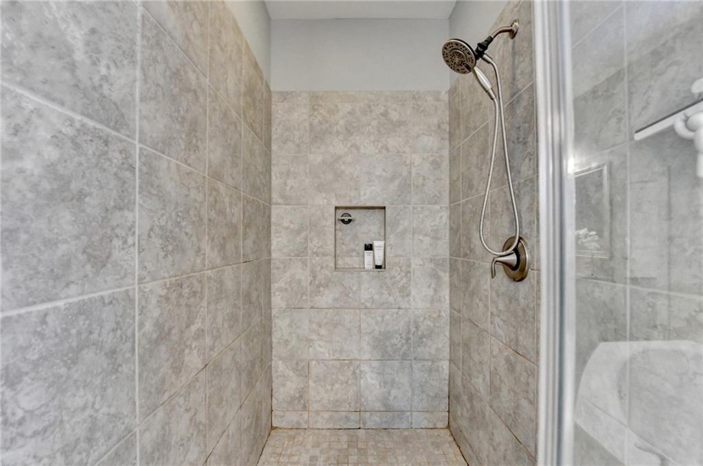 4071 Woodward Walk Lane Suwanee, GA 30024 - Photo 32 of 50 a bathroom with a shower