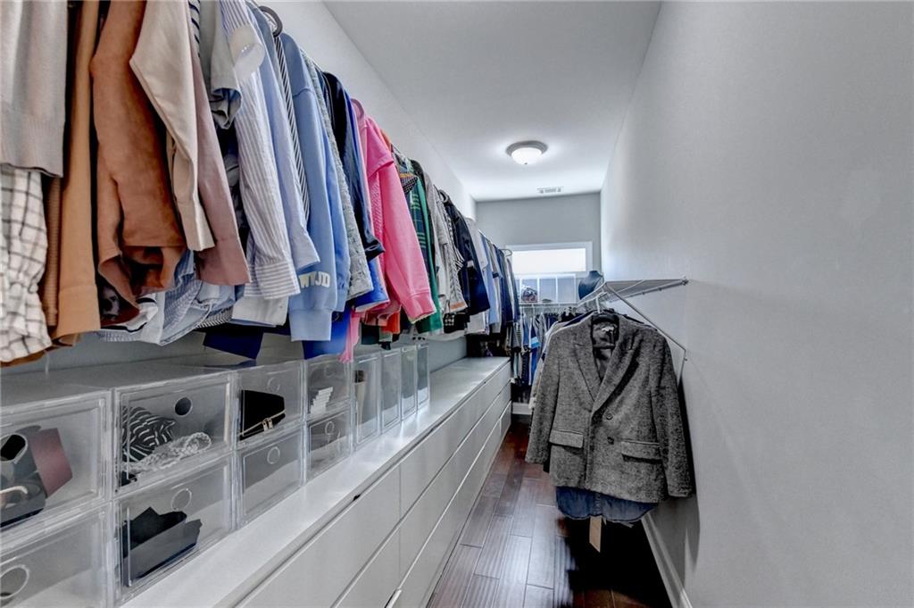 4071 Woodward Walk Lane Suwanee, GA 30024 - Photo 33 of 50 a view of walk in closet with clothes and shoes