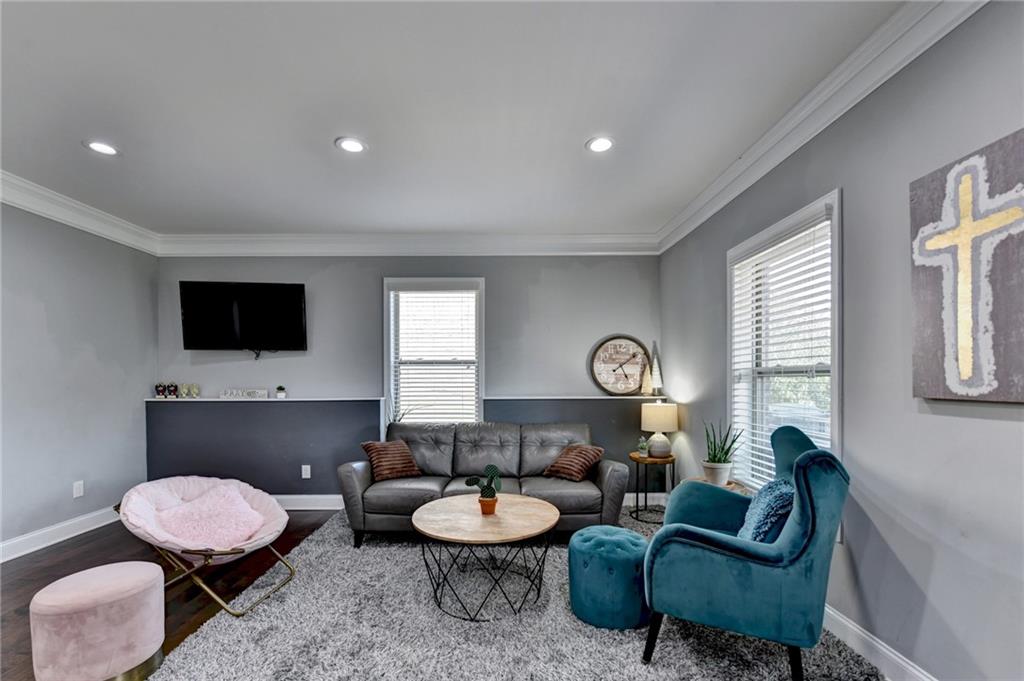 4071 Woodward Walk Lane Suwanee, GA 30024 - Photo 35 of 50 a living room with furniture and a flat screen tv