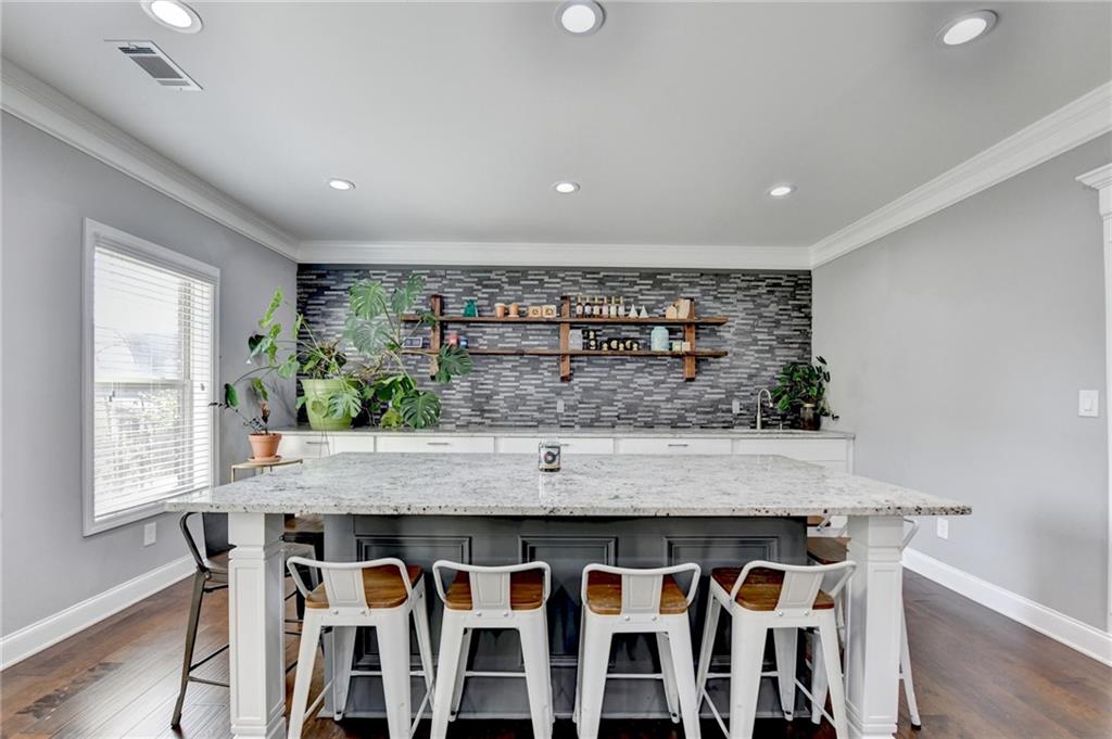 4071 Woodward Walk Lane Suwanee, GA 30024 - Photo 36 of 50 a kitchen with stainless steel appliances granite countertop a table and chairs in it