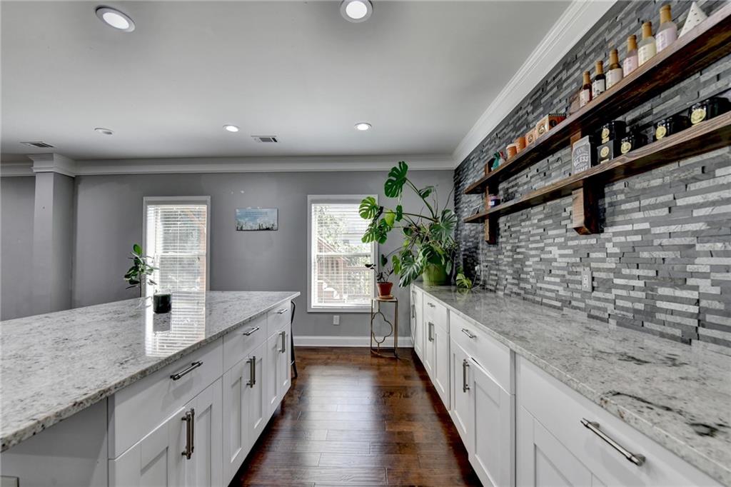 4071 Woodward Walk Lane Suwanee, GA 30024 - Photo 37 of 50 a large white kitchen with a large counter space