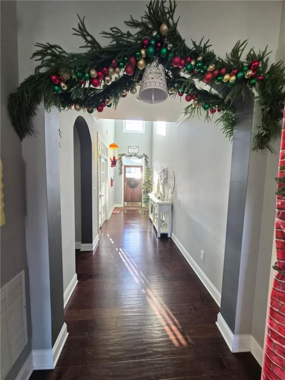 4071 Woodward Walk Lane Suwanee, GA 30024 - Photo 5 of 50 a view of a hallway with a flower pot and a bookshelf