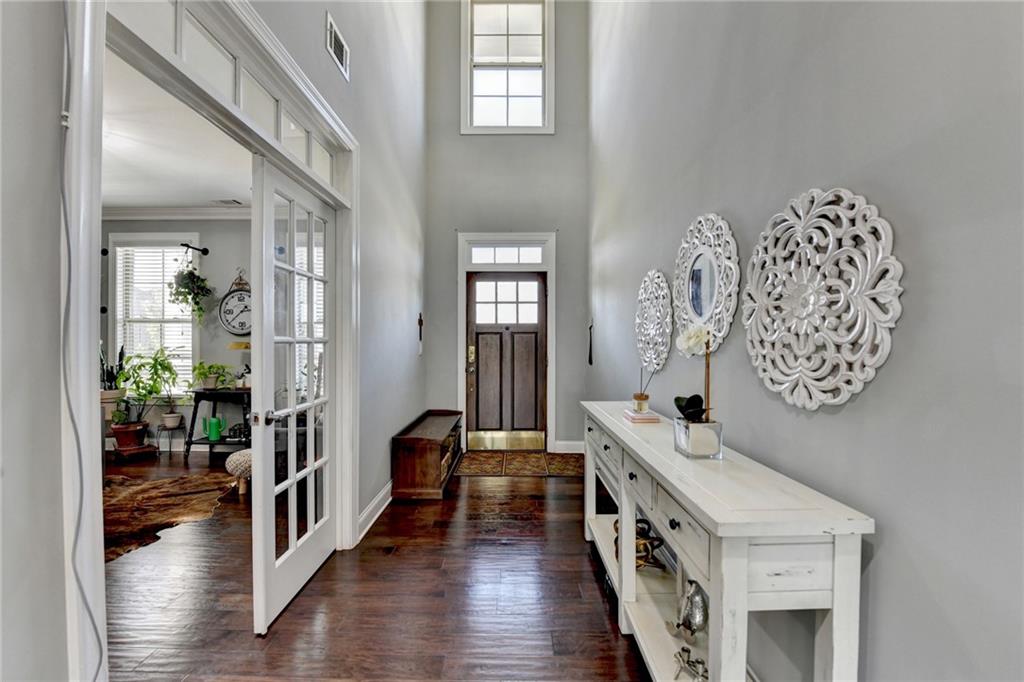 4071 Woodward Walk Lane Suwanee, GA 30024 - Photo 8 of 50 a view of a hallway view with wooden floor and staircase