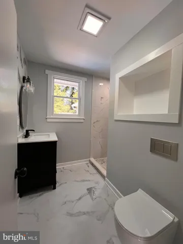a bathroom with a toilet sink and mirror