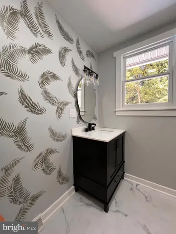 a bathroom with a sink and mirror