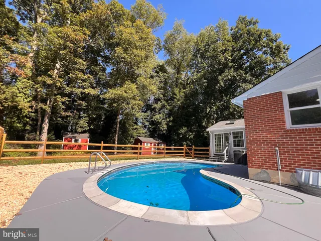 a view of a swimming pool with an outdoor seating