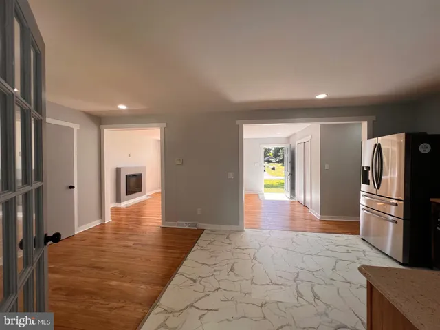 a view of a refrigerator in kitchen and wooden floor