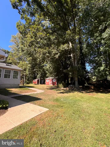a view of a house with a yard and garage