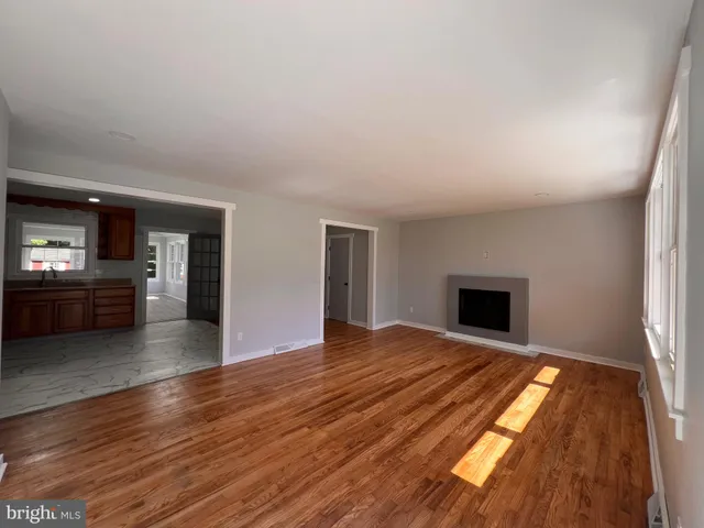 a view of kitchen and hall with wooden floor