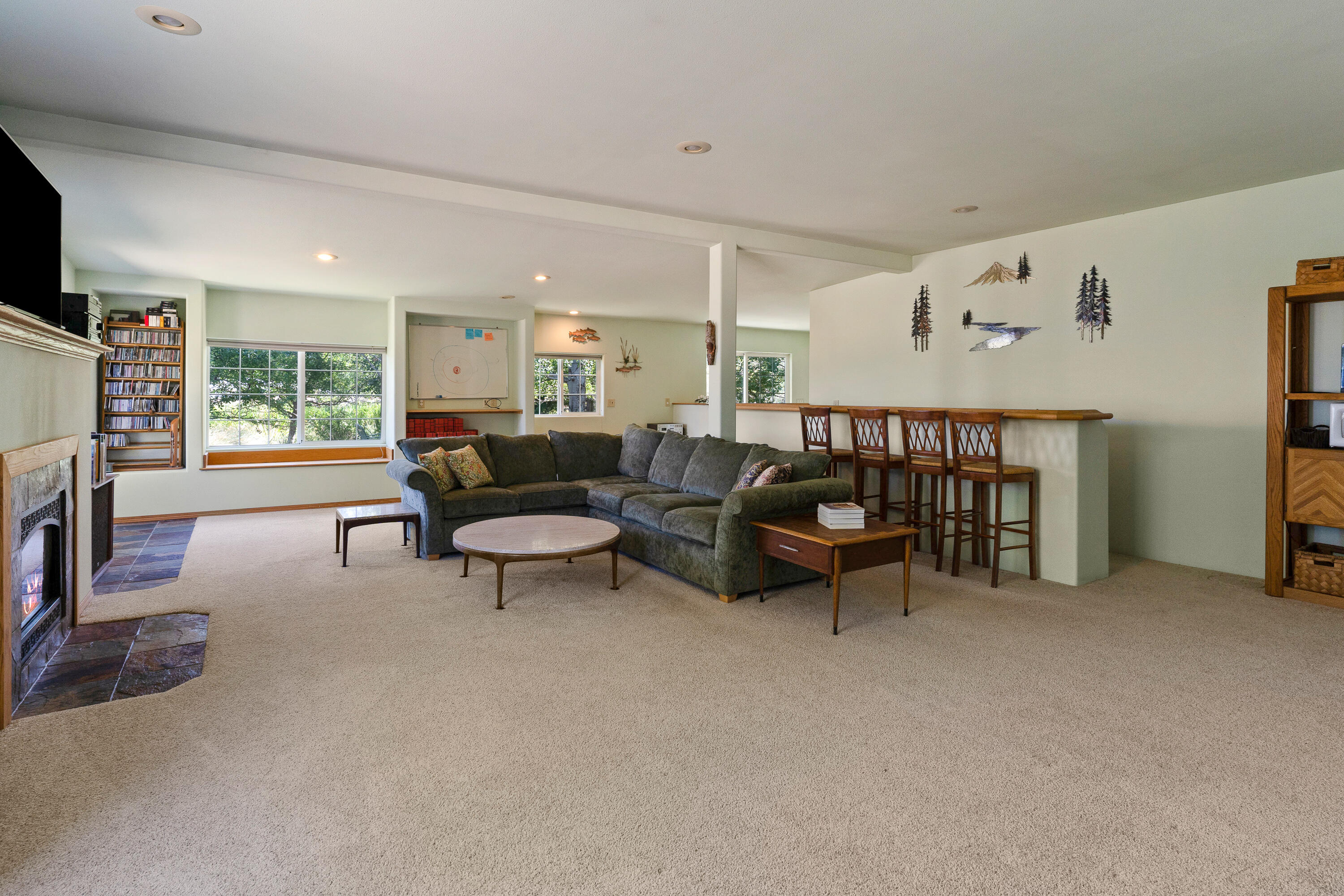 60297 Tekampe Road Bend, OR 97702 - Photo 27 of 33 a living room with furniture and a flat screen tv