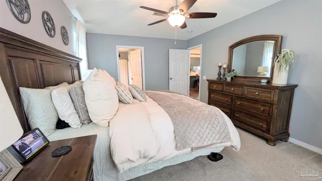a bedroom with a bed and a mirror on dresser