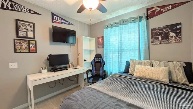 a bedroom with a bed and a flat screen tv