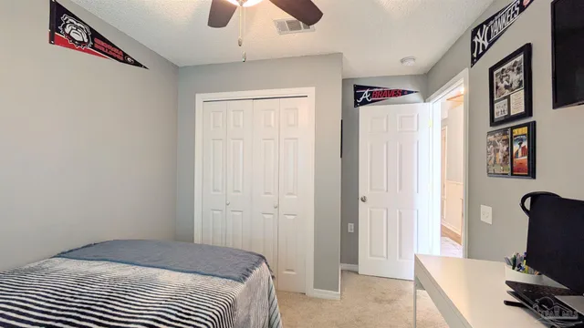 a bedroom with a bed and a chair