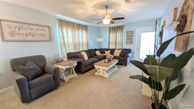 a living room with furniture potted plant and a window
