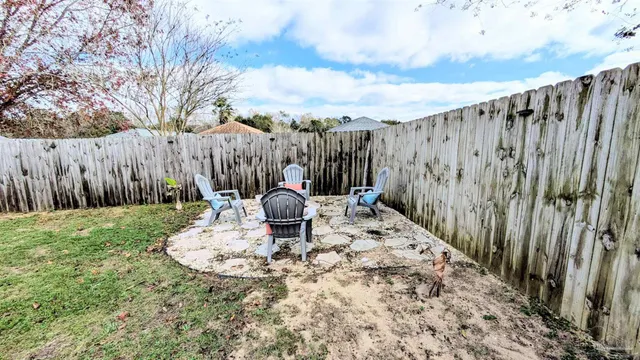 a view of a backyard with table and chairs