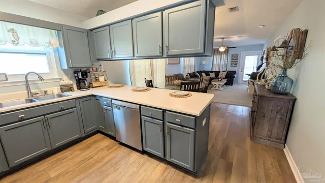 a kitchen with a sink appliances and cabinets