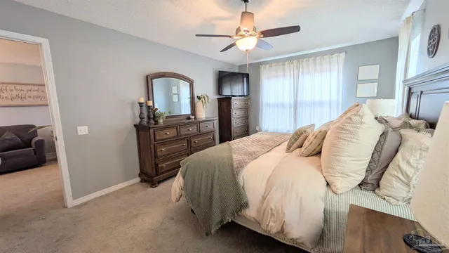 a bedroom with a bed dresser and a window