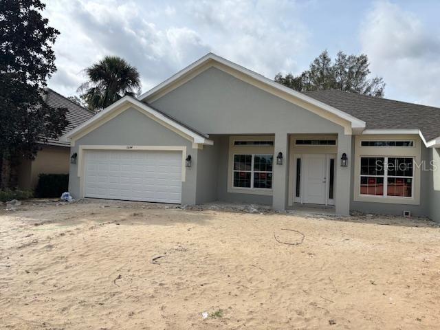 6644 Southwest 179th Ave Road Dunnellon, FL 34432 - Photo 1 of 1 a front view of a house with a yard and garage