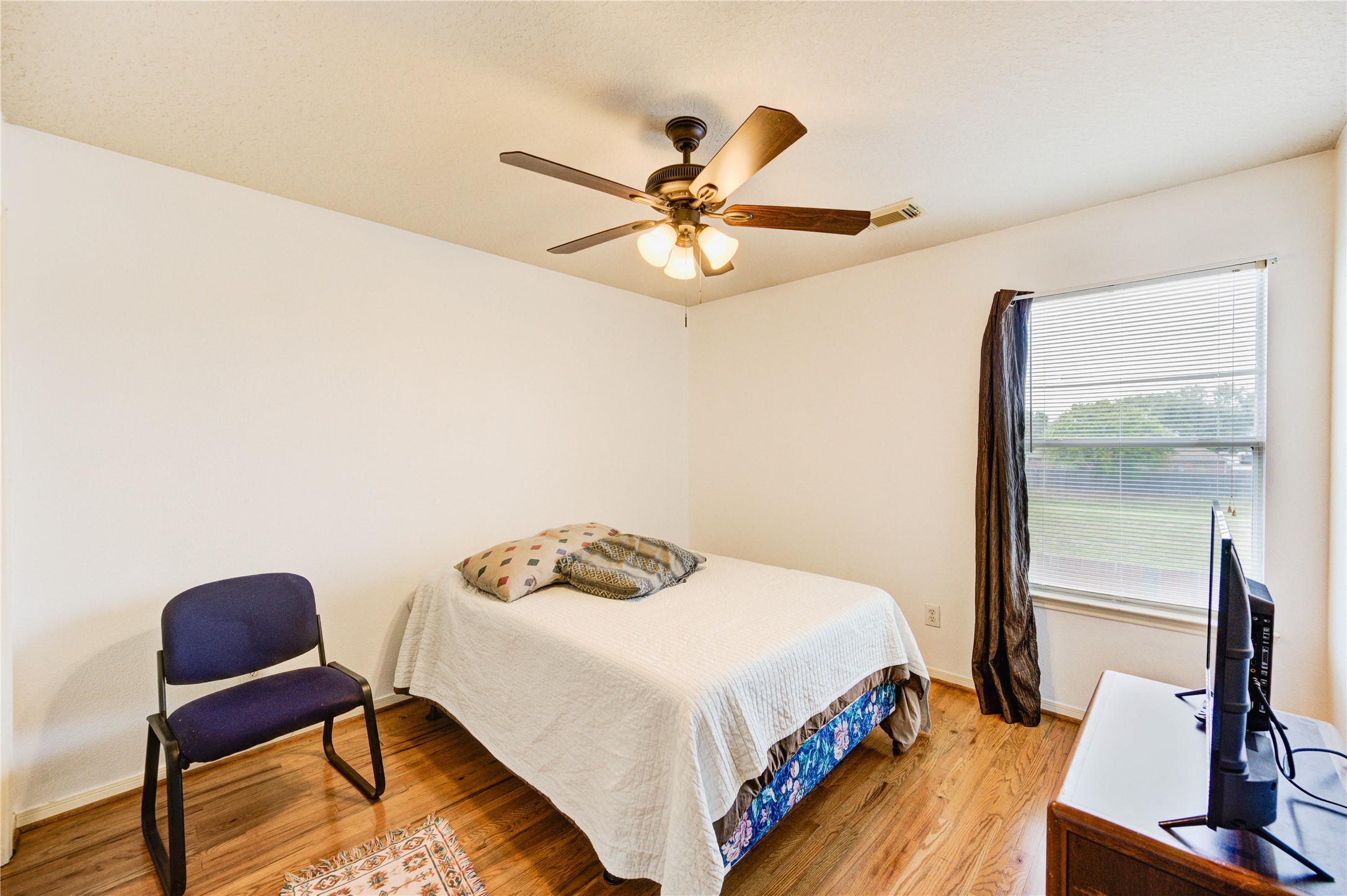 16730 Spring Barker Drive Cypress, TX 77429 - Photo 44 of 50 a bedroom with a bed and a chandelier