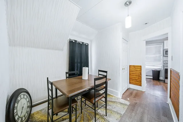 a kitchen with stainless steel appliances granite countertop a stove top oven a sink and white cabinets