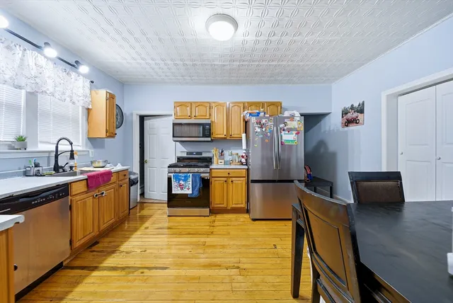 a kitchen with stainless steel appliances a stove refrigerator sink and microwave
