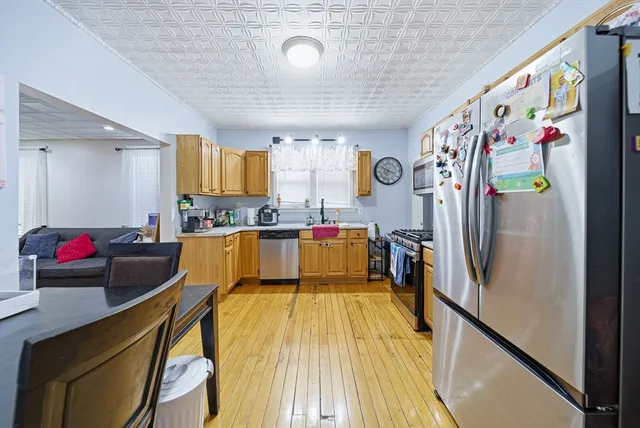 a view of a kitchen with fridge and a window