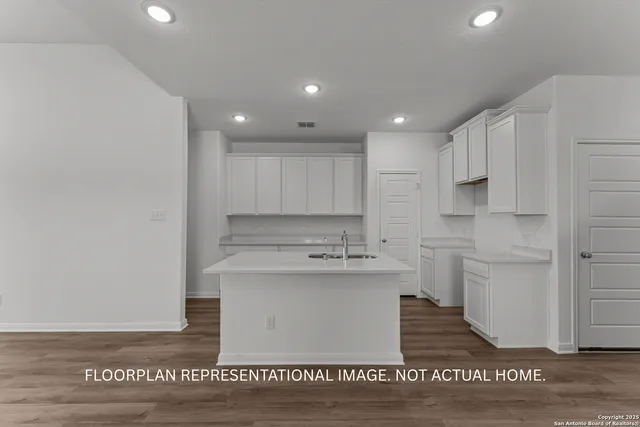 a view of empty room with wooden floor and ceiling fan