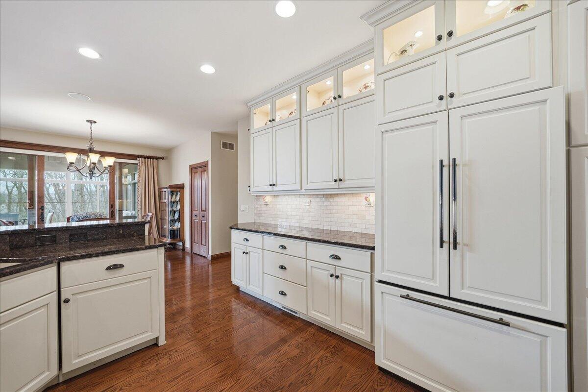 770 Quinlan Court Crown Point, IN 46307 - Photo 11 of 57 a kitchen with granite countertop cabinets and wooden floor