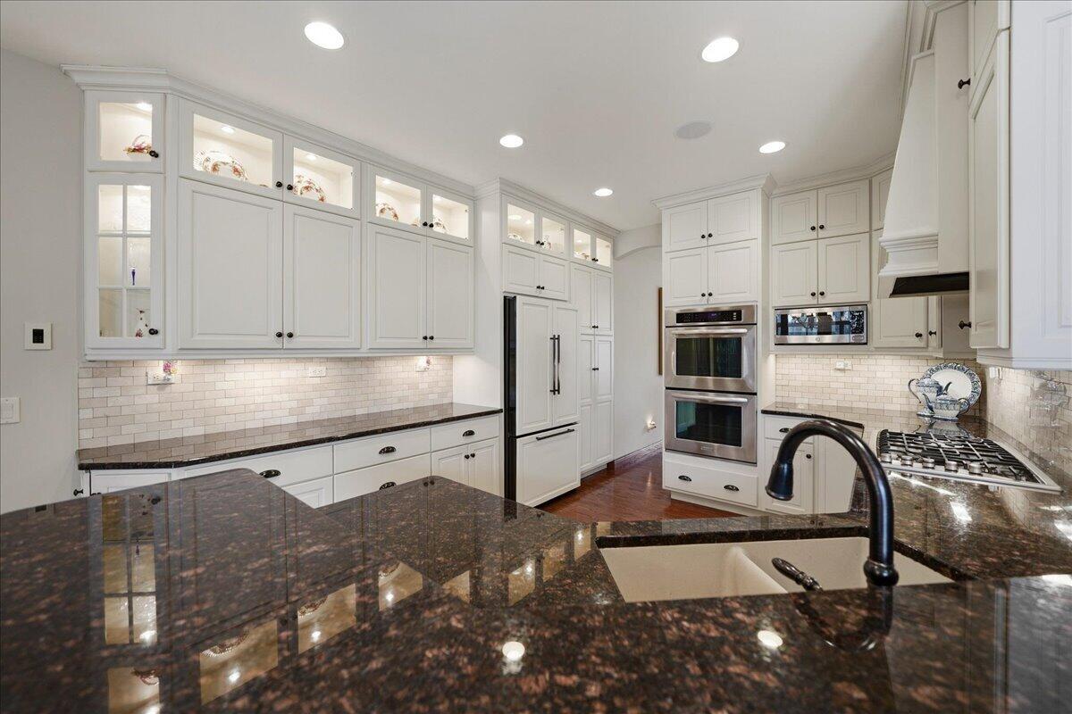 770 Quinlan Court Crown Point, IN 46307 - Photo 12 of 57 a kitchen with stainless steel appliances granite countertop a stove a sink and a refrigerator