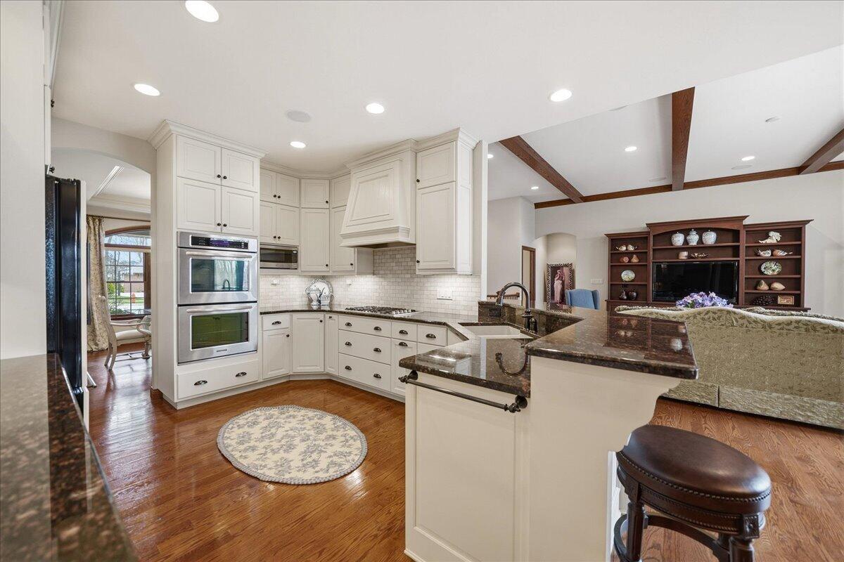 770 Quinlan Court Crown Point, IN 46307 - Photo 13 of 57 a kitchen with stainless steel appliances granite countertop a sink and cabinets