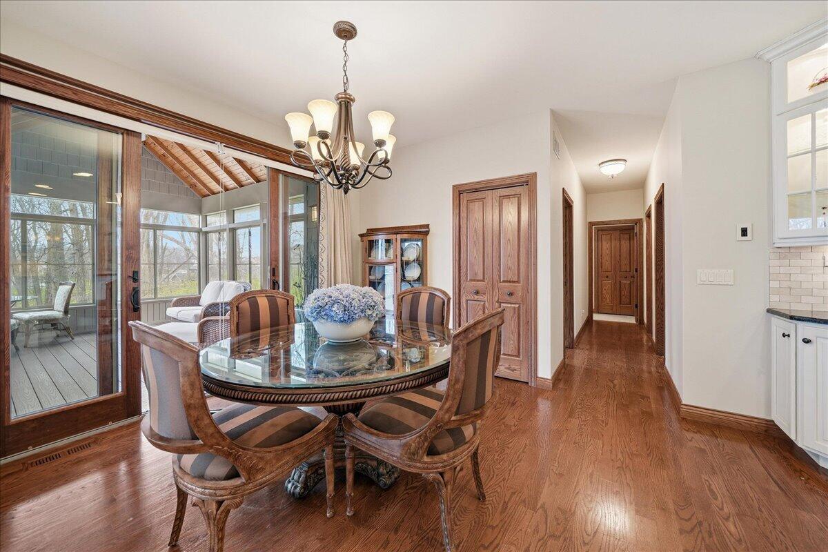 770 Quinlan Court Crown Point, IN 46307 - Photo 19 of 57 a view of a dining room with furniture wooden floor and chandelier