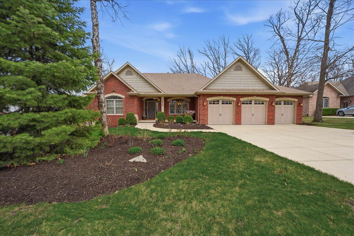 770 Quinlan Court Crown Point, IN 46307 - Photo 2 of 57 a front view of a house with a garden and trees