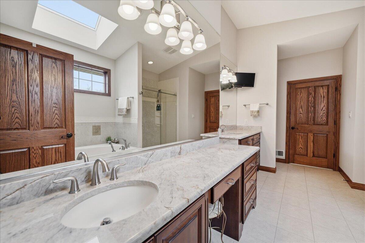 770 Quinlan Court Crown Point, IN 46307 - Photo 26 of 57 a bathroom with a granite countertop sink a mirror and shower