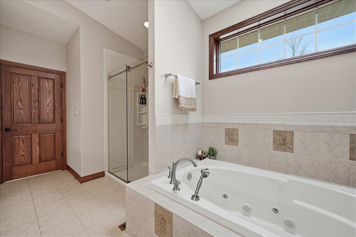 770 Quinlan Court Crown Point, IN 46307 - Photo 27 of 57 a bathroom with a tub and a shower