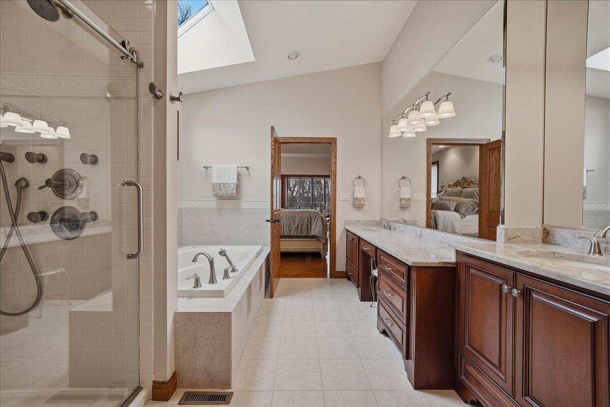 770 Quinlan Court Crown Point, IN 46307 - Photo 28 of 57 a spacious bathroom with a granite countertop sink and a mirror