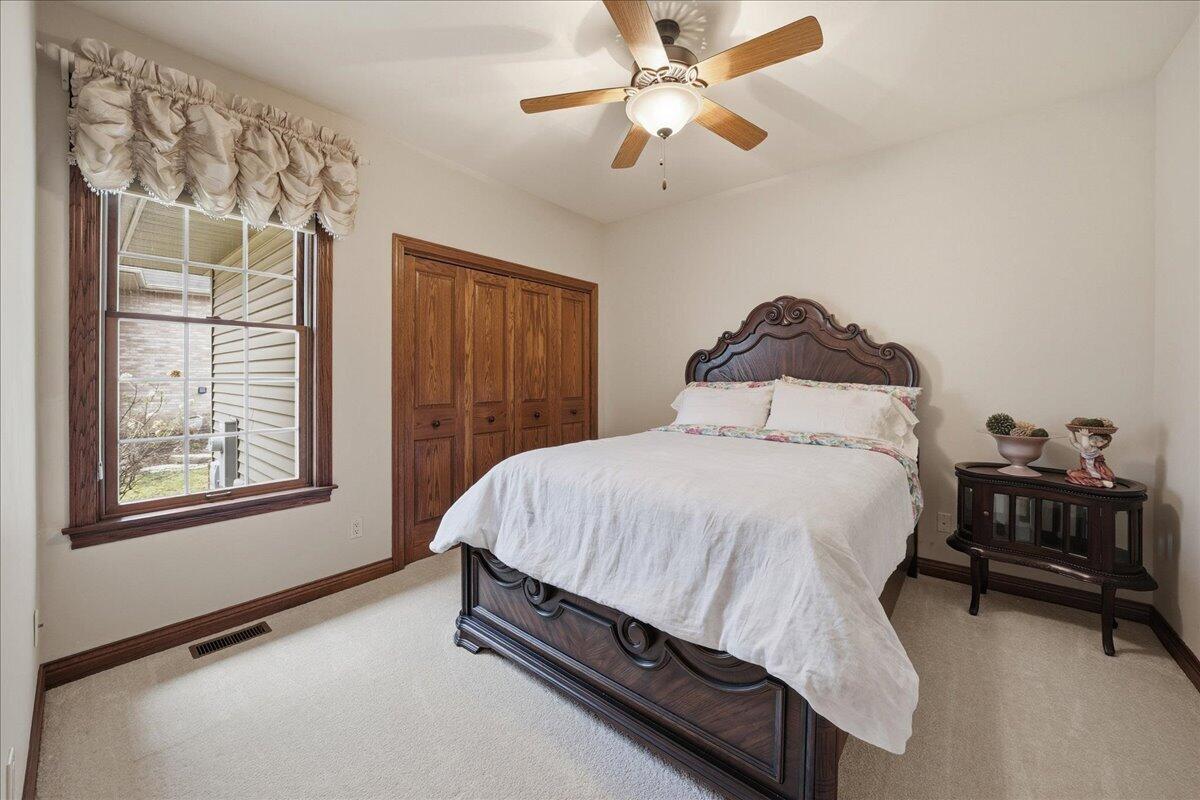 770 Quinlan Court Crown Point, IN 46307 - Photo 32 of 57 a bedroom with a bed dresser and a window
